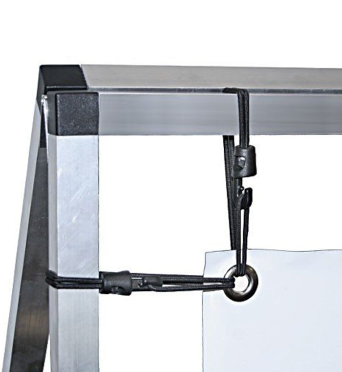 Close-up view of a banner frame's corner showing the secure bungee and hook fastening system.
