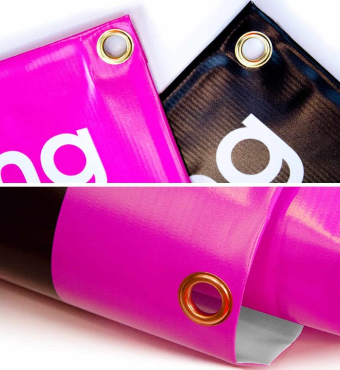 Corner of a bright pink PVC banner with metal eyelets from Edinburgh Banners.