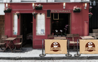 Elegant Red Exterior Cafe With Outdoor Seating, Flowers, And “Coffee Place” Banners In Edinburgh.