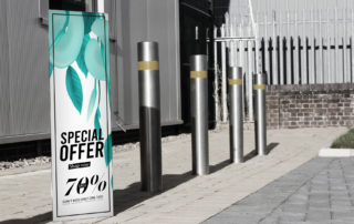 Bollard cover advertising a 'Special Offer' with a 70% discount in a street setting.